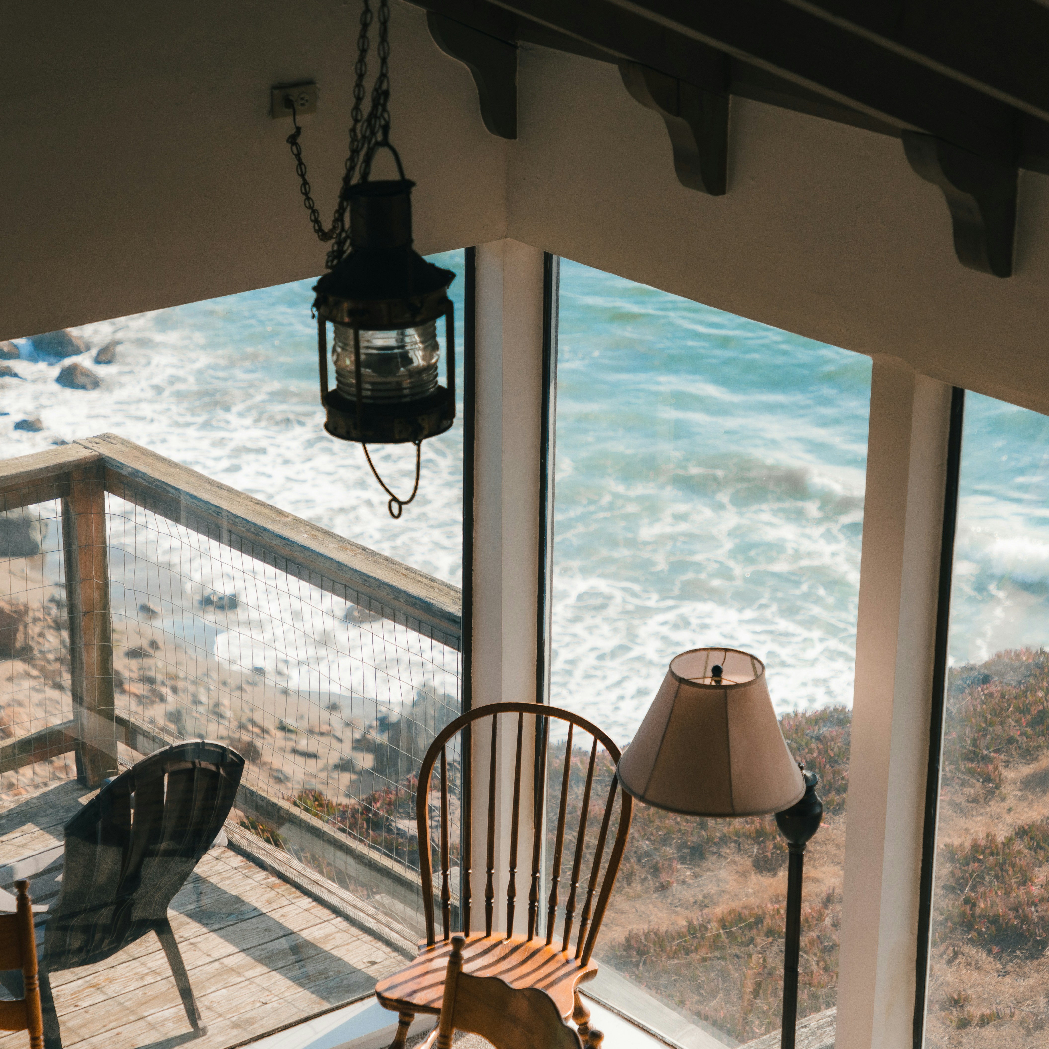 photo of a room with a bed and a window with sunglight streaming in